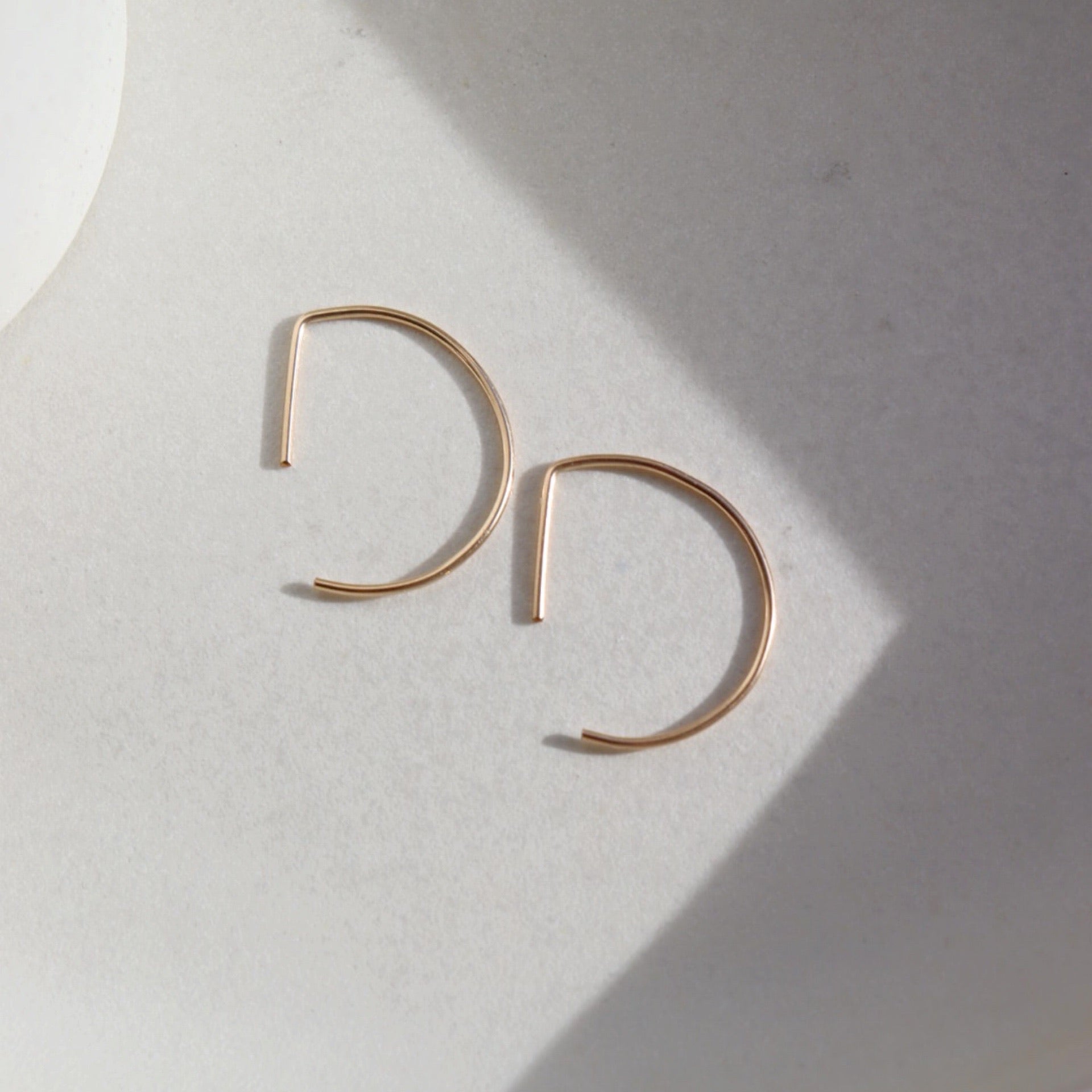 Half circle threader earring made from 14k gold fill or sterling silver. Handmade by Token Jewelry in Eau Claire, WI