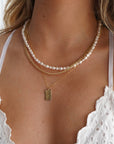 Model wearing 14k gold fill Endless pearl necklace. 