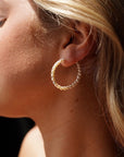 Model wearing 14k gold fill Pearl Halo Hoops