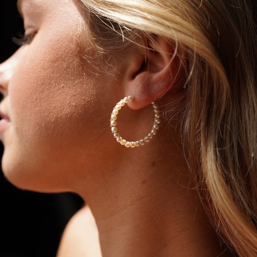 Model wearing 14k gold fill Pearl Halo Hoops