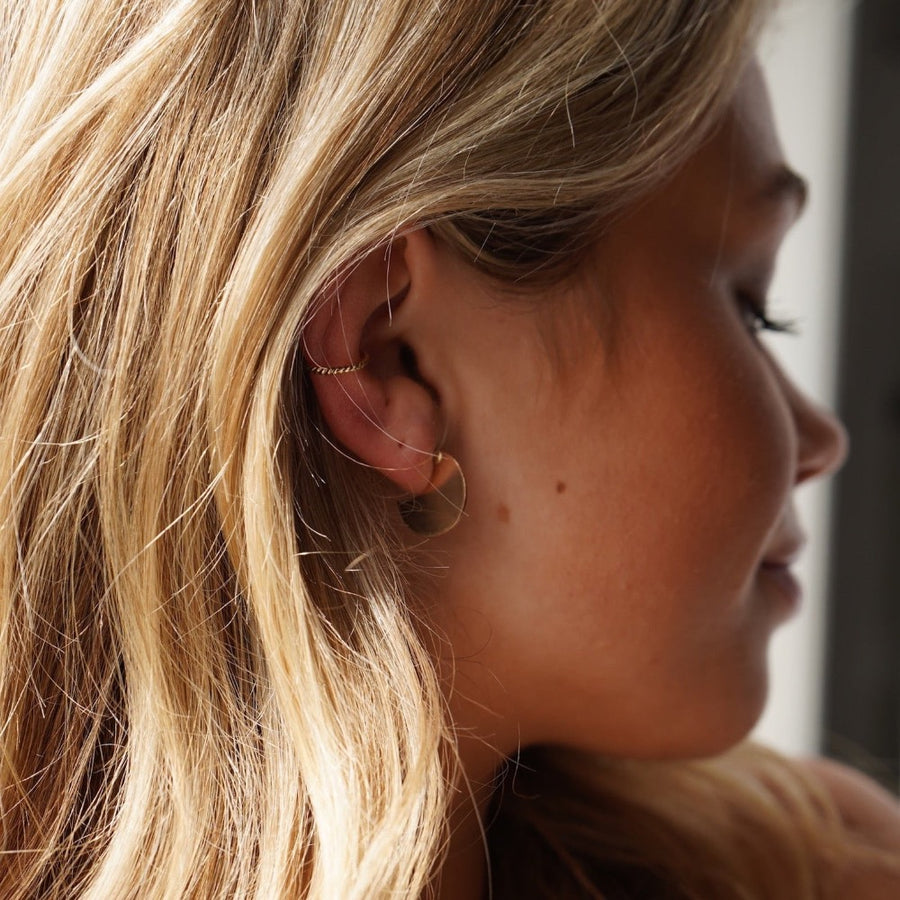 Model Wearing 14k gold fill Mini Echo Studs paired with a spiral ear cuff.