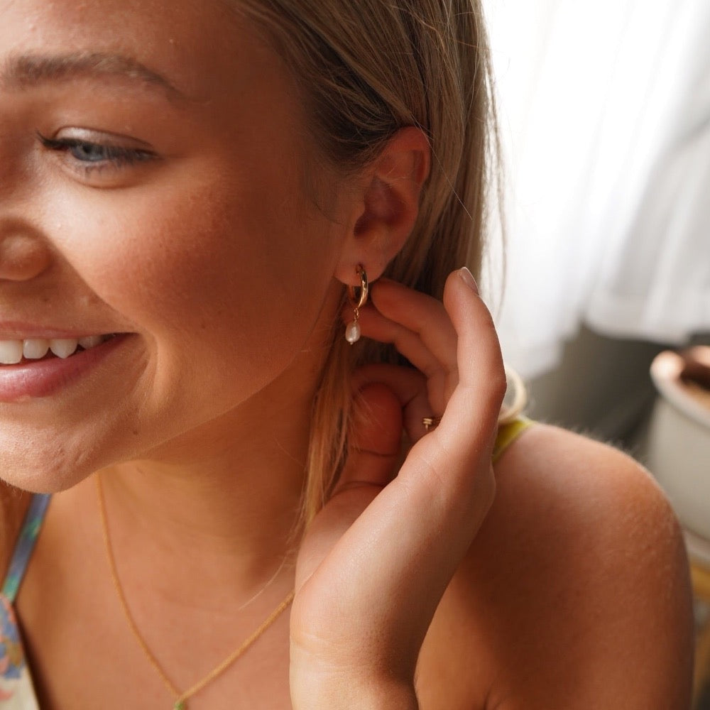 Model wearing 14k gold fill Classic Pearl Hoops 