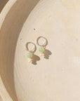 Sterling Silver hoops with chalcedony and ethiopian opal beads on a light dish