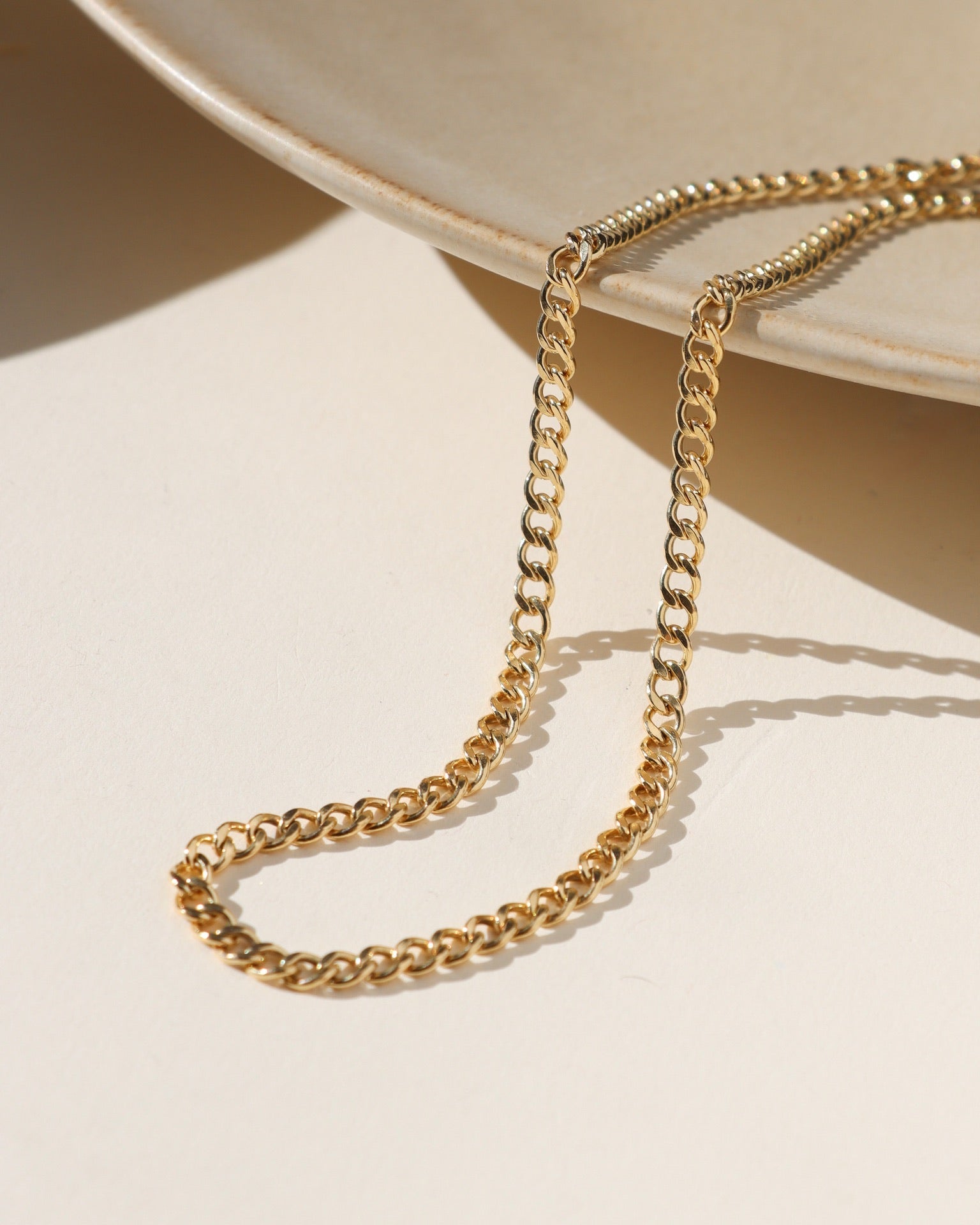 14k gold fill curb chain in the sunlight