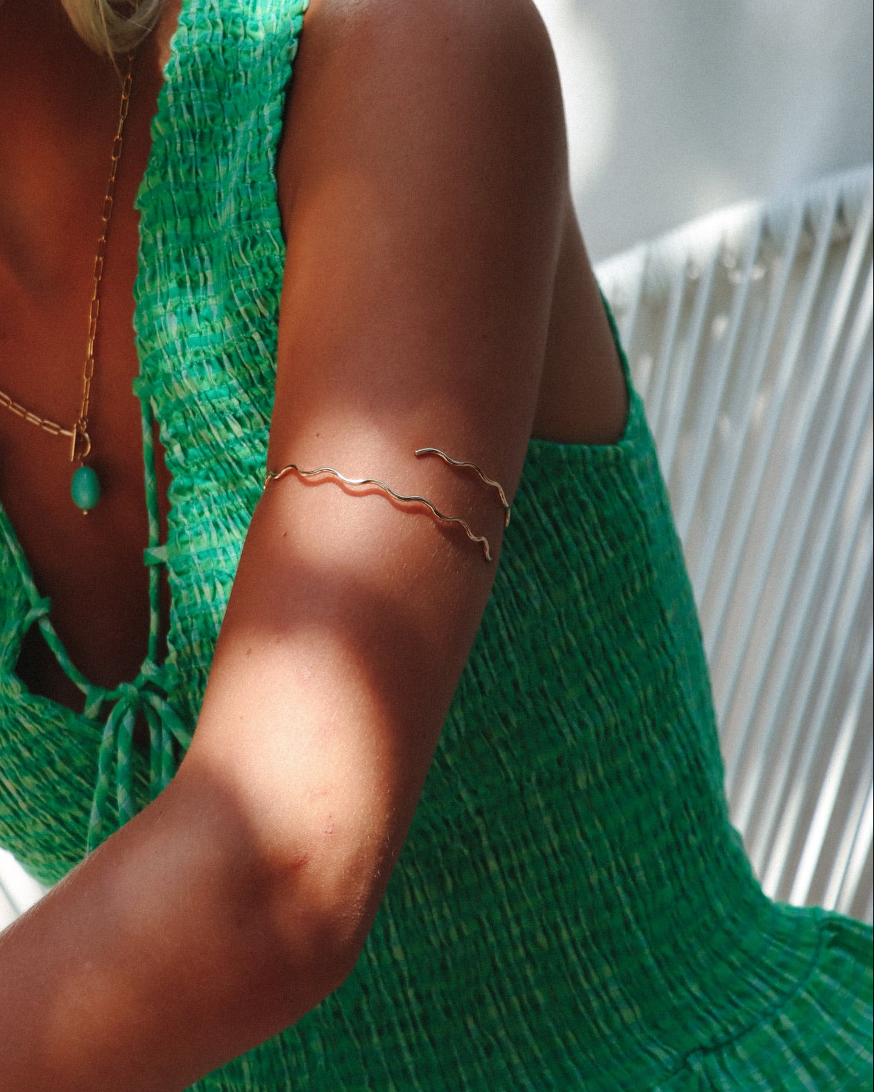 model wearing 14k gold fill wavy arm cuff 