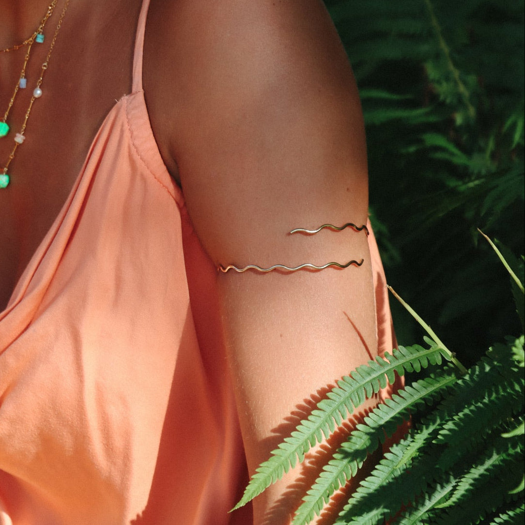model wearing 14k gold fill wavy arm cuff 