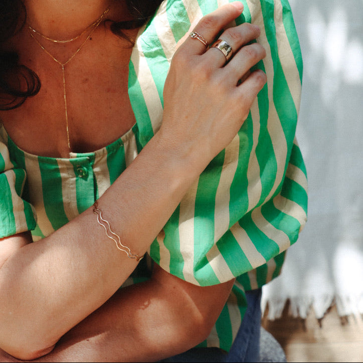 model wearing 14k gold fill wavy bangle 
