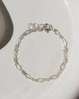child's size curvy chain linked bracelet in 925 Sterling Silver. Spring hook clasp closure and half inch extender to make the bracelet adjustable. Handmade by Token Jewelry in Eau Claire, WI
