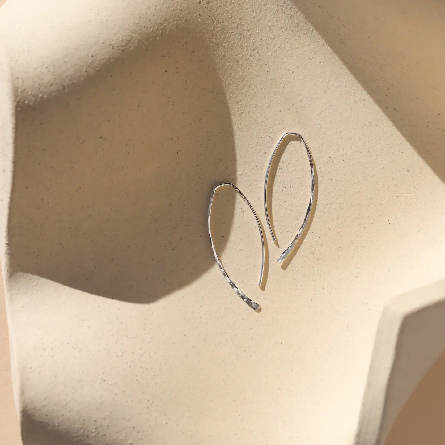 sterling silver hammered earrings on a light dish