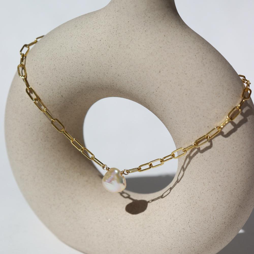 Eden anklet in 14k gold fill  on a tan pot