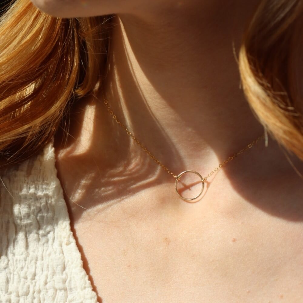model wearing 14k gold fill hammered circle pendant on a delicate chain necklace 