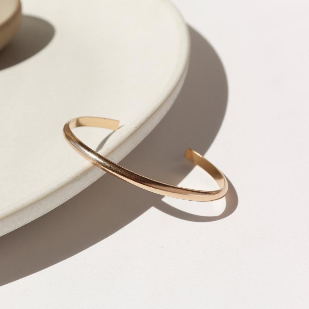 Everyday cuff laid on a white plate in the sunlight