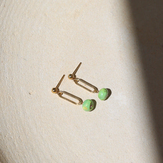 14k gold fill stud earrings with turquoise bead drops on a light dish