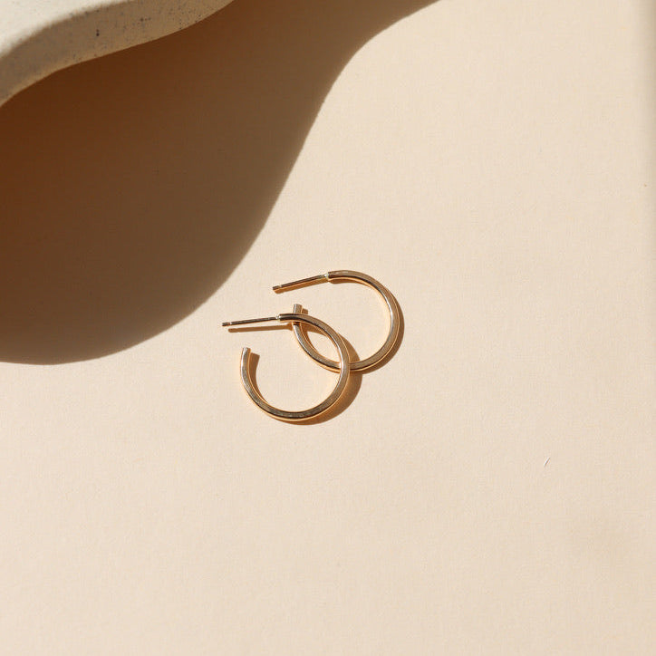 14k gold fill hammered hoops on a light background