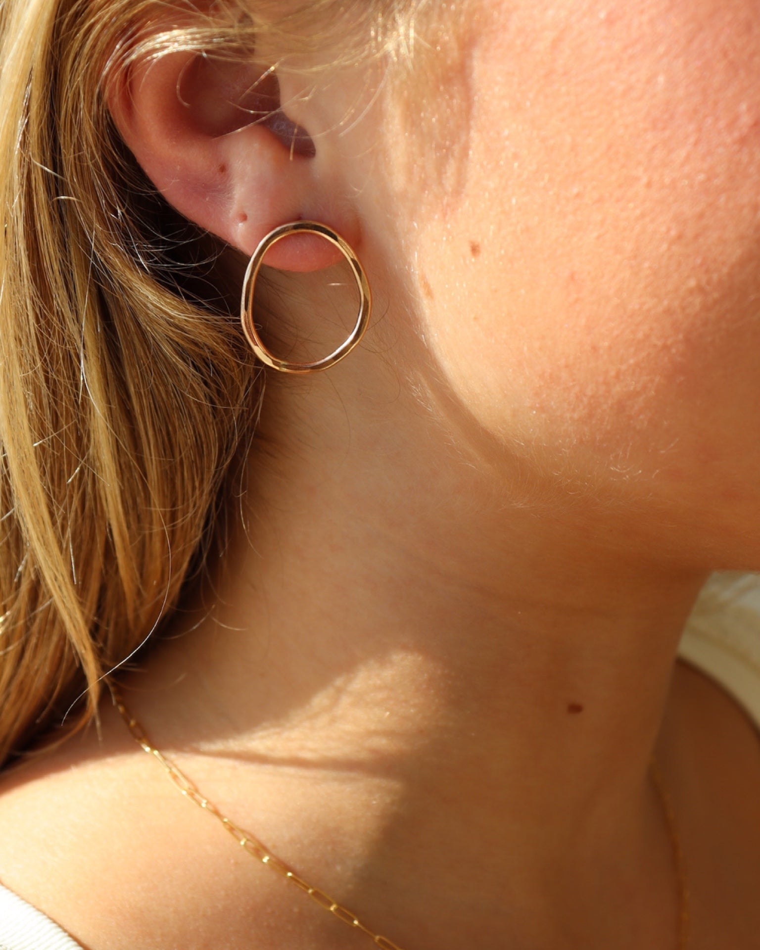 Form Studs in 14k gold fill worn by a model 