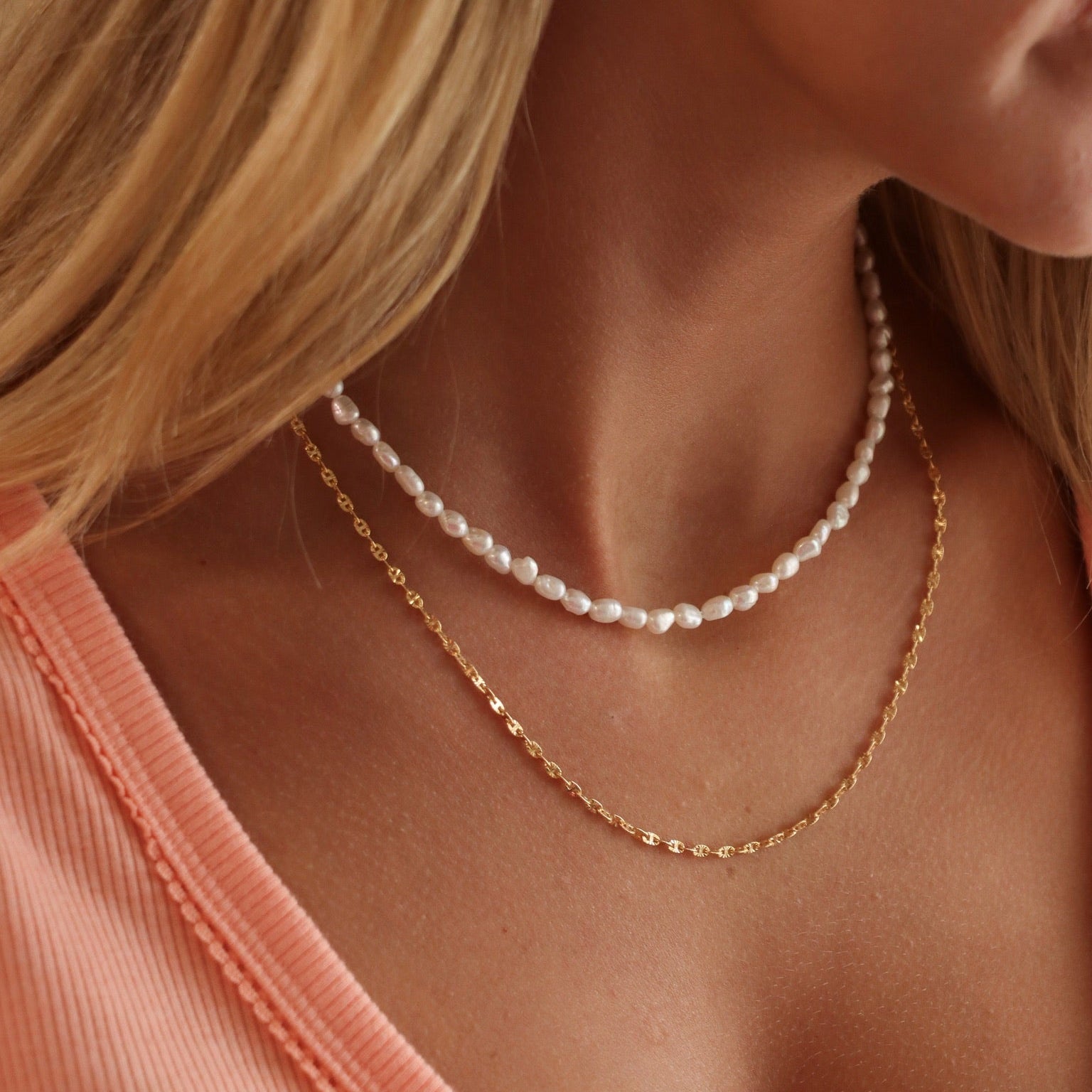model wearing 14k gold fill chain necklace with hand beaded pearl necklace