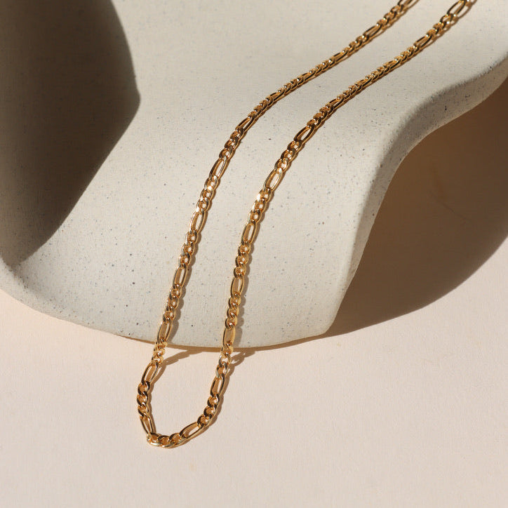 14k gold fill chunky figaro chain on a light dish