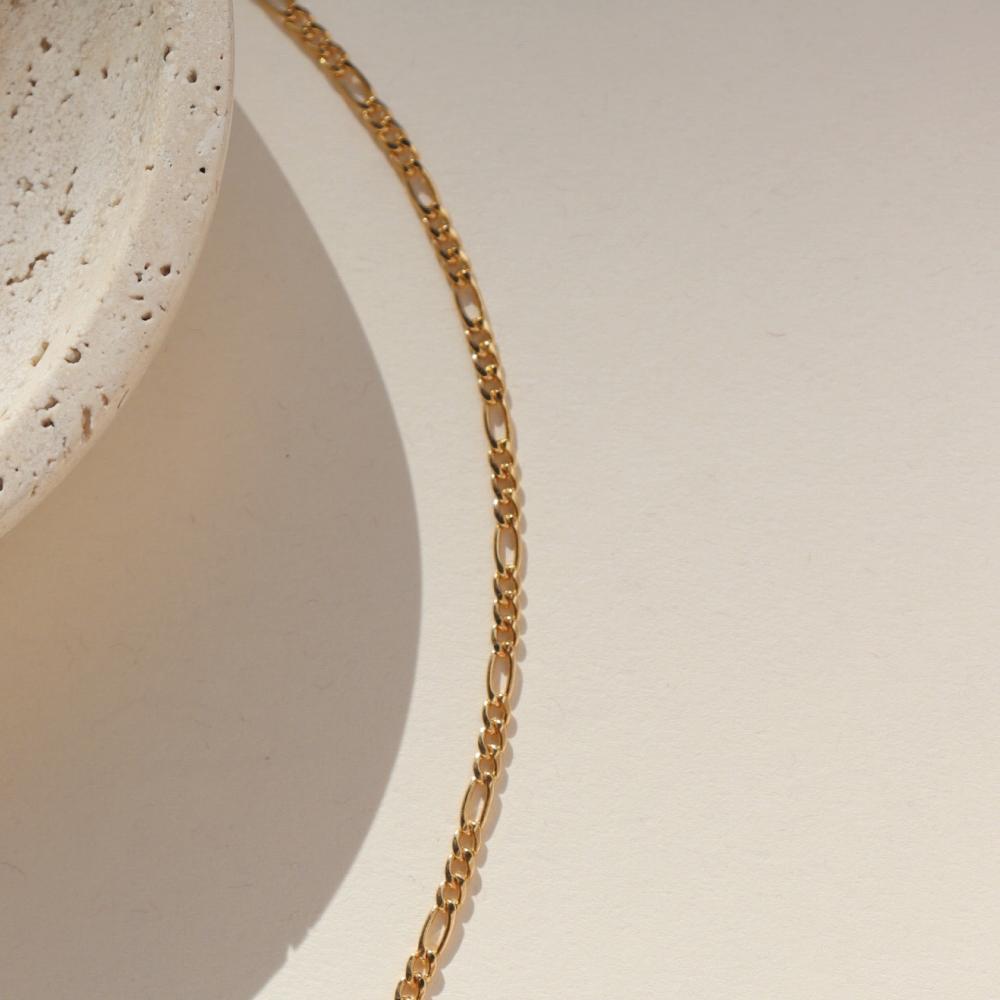14k gold fill chunky figaro chain on a light dish