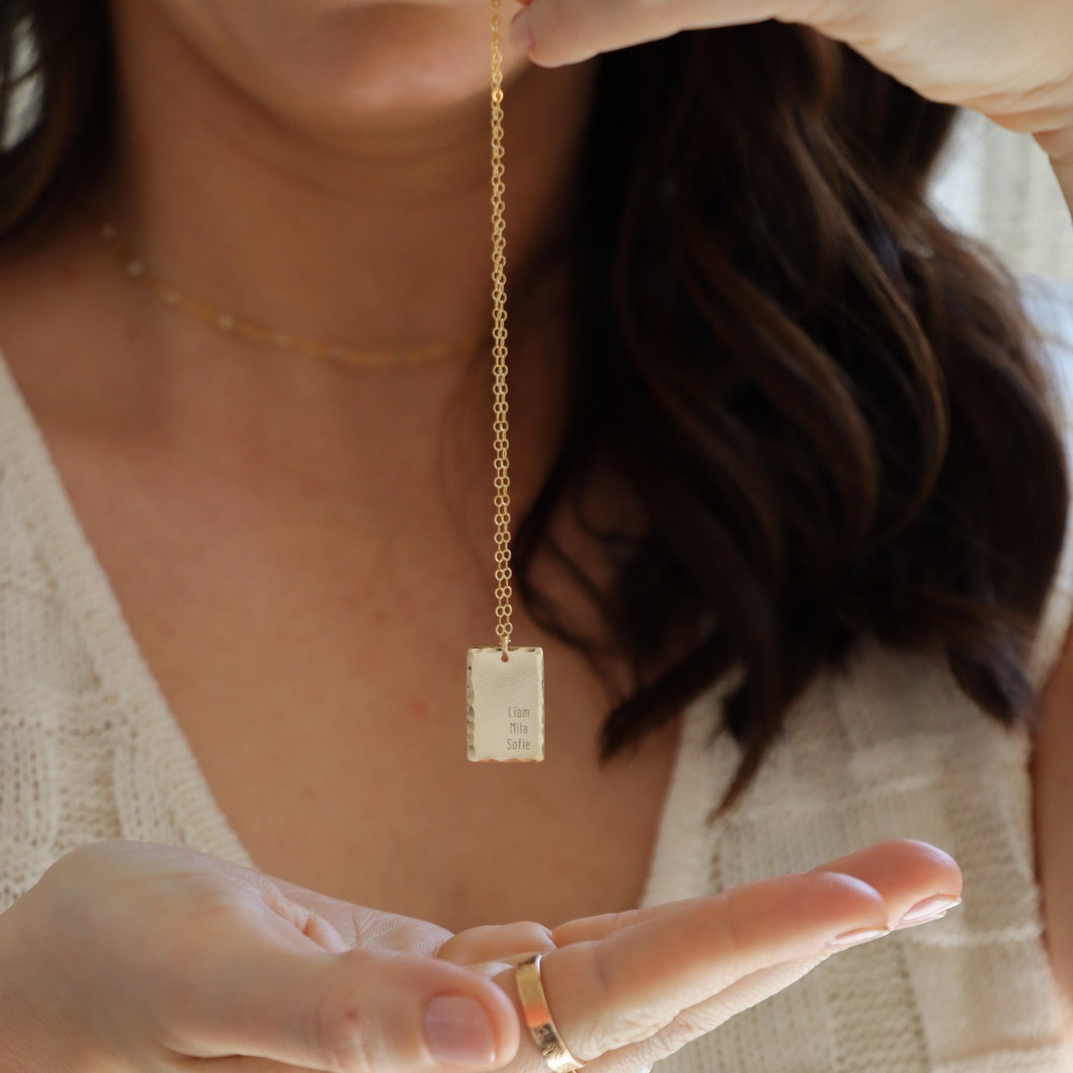 Gold fill engraved Keepsake necklace model holding in hand 