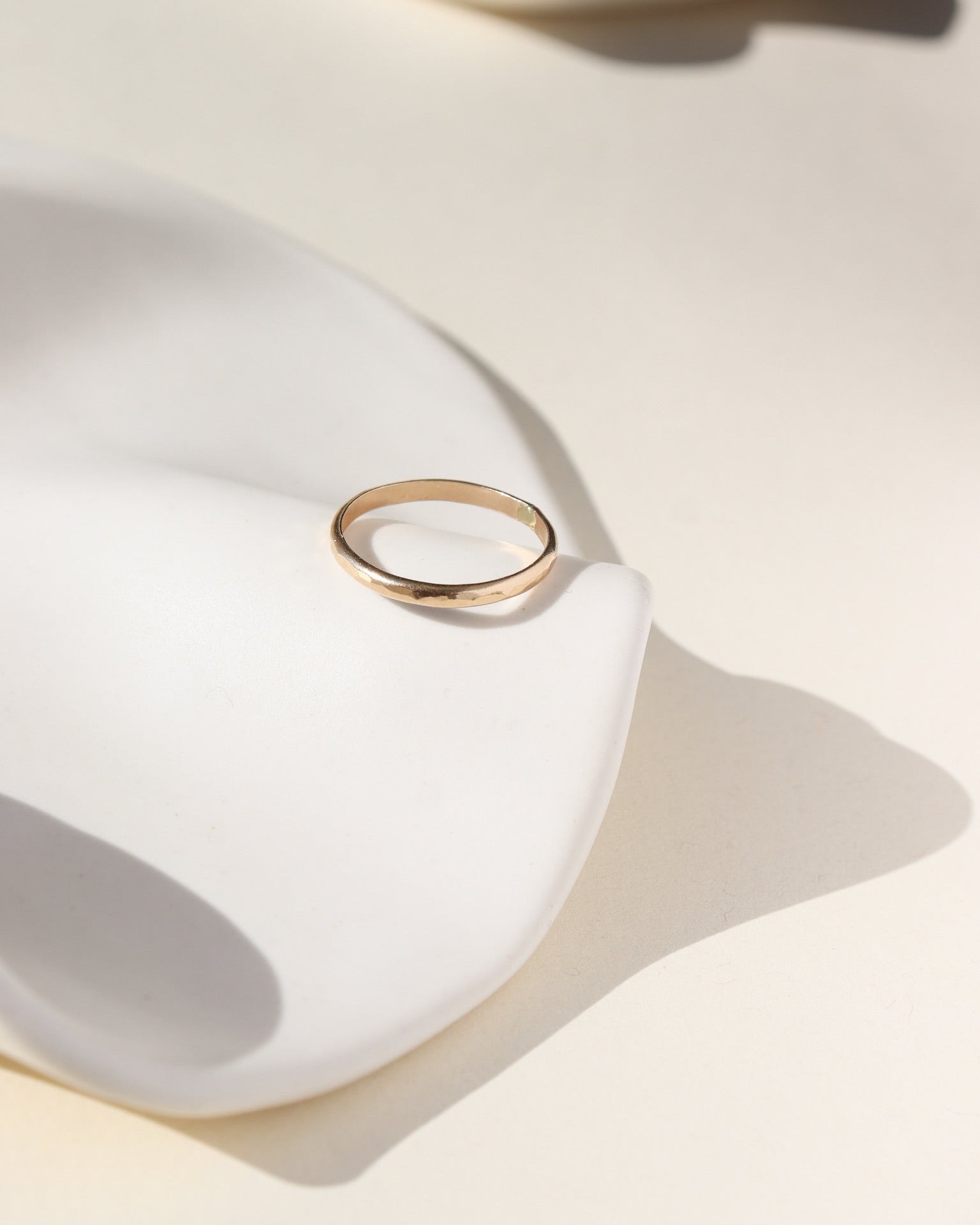 lightly textured 14k solid gold circle ring in the sunlight