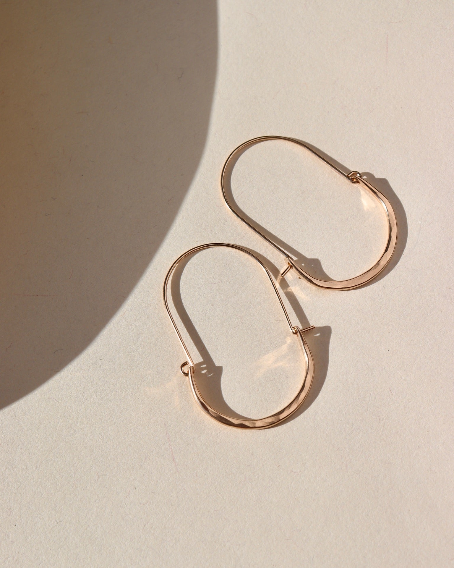 14k gold fill long hoop earrings on a light background