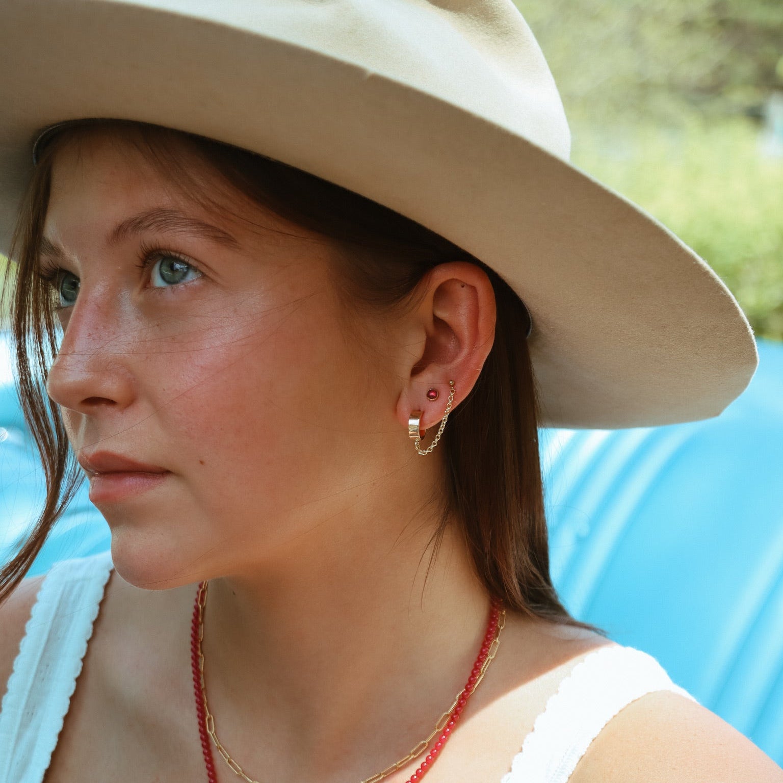 model wearing 14k gold fill chain studs with ruby studs
