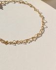 14k gold fill linked heart chain bracelet on a sunny backdrop