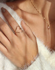 Model wearing a hammered open heart shaped ring made with 14k gold fill wire. 