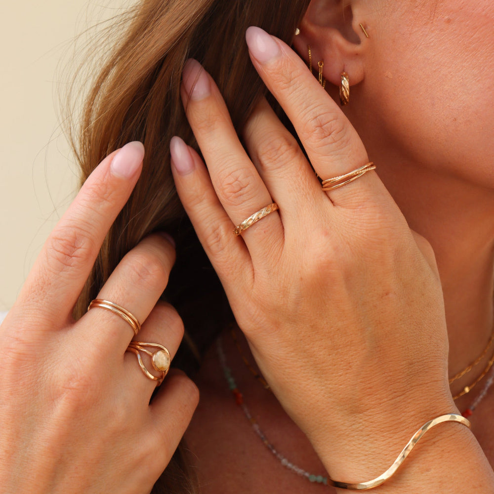 close up shot of model wearing 14k gold fill jewelry