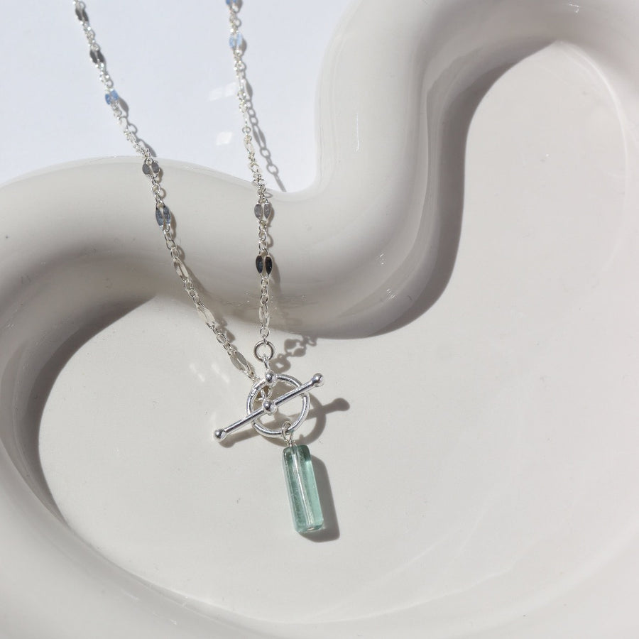 925 Sterling silver Flynn Toggle Necklace. This Necklace Features a Simple Toggle connector with a Dangle Fluorite tube gemstone . The toggle is held together with the Sylvie chain.