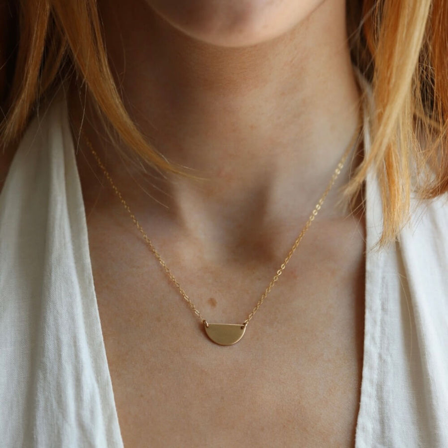 Model wearing 14k gold fill Sunrise Necklace - Token Jewelry - hand cut 14k gold fill or sterling silver sheet metal - half circle sunrise horizon shape - hanging from chain - locally handmade in our Eau Claire, WI studio - Token Jewelry