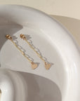 14k gold fill chain stud earring backs with a heart charm photographed on a ceramic dish