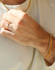 Model wearing 14k gold fill Alex Bracelet paired with the la mer bracelet.