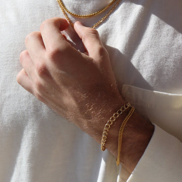Model wearing 14k gold fill Alex Bracelet paired with the la mer bracelet.