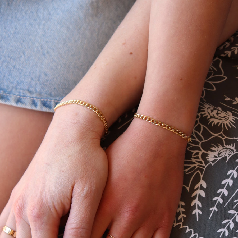 a mother and daughter's hands both wearing matching Demi Alexandra Chains, a 14k gold fill bold link chain