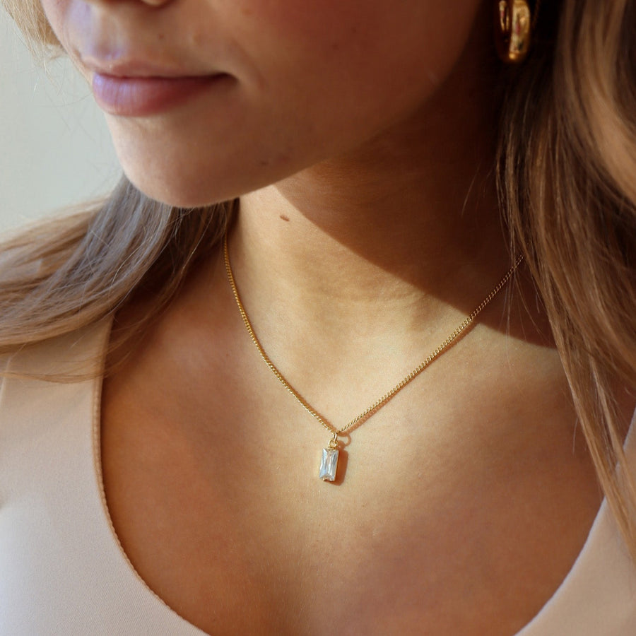 Model is wearing the 14k gold fill Euphoria Necklace, along with other earrings from Token Jewelry. Jewelry is hypoallergenic and nickel free, handmade in Eau Claire, Wisconsin.