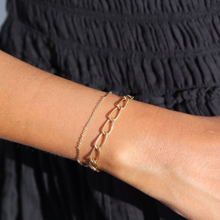 Model wearing 14k gold fill sailor bracelet paired with the curve bracelet