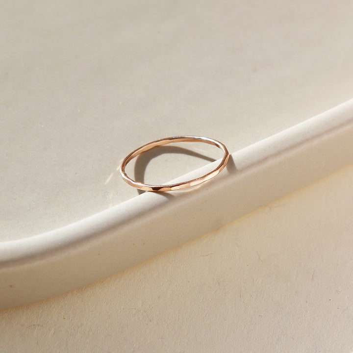 dainty hammered rose gold stacking ring handcrafted by Token Jewelry in Eau Claire, Wisconsin