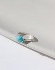 Sterling Silver turquoise gemstone ring photographed on ceramic dish, handmade by Token Jewelry