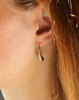 model wearing 14k gold fill Golden Drop Earrings - Token Jewelry