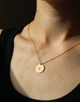 Model wearing 14k gold fill Initial Coin Necklace 5/8" 