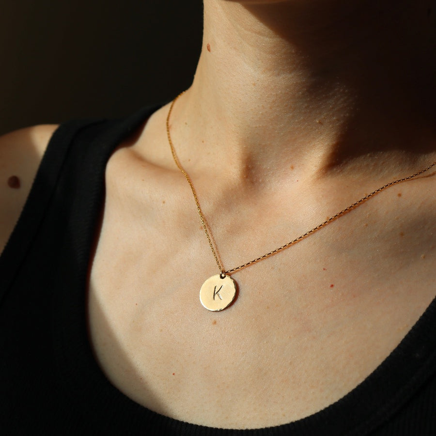 Model wearing 14k gold fill Initial Coin Necklace 5/8" 