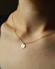 Model wearing 14k gold fill small monogram coin necklace 3/8"