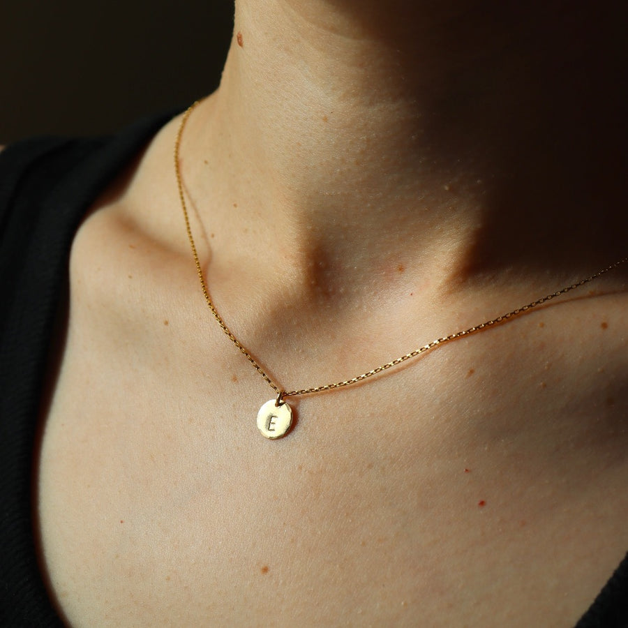 Model wearing 14k gold fill small monogram coin necklace 3/8"