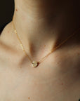 Model wearing a 16" 14k gold fill Anchored Initial Necklace with the initial "H" stamped on the coin pendent.