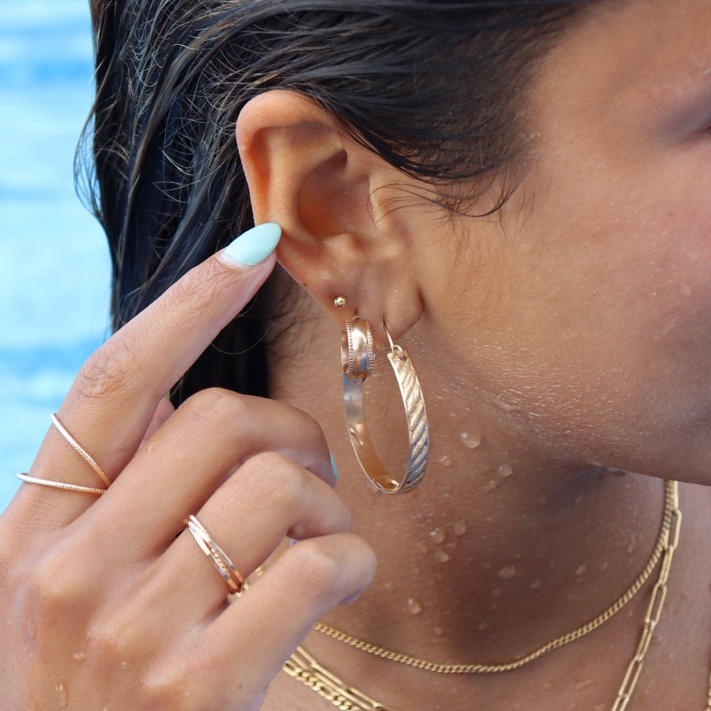 14k gold filled ripple hoops on a model that is swimming.