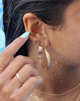 14k gold filled ripple hoops on a model that is swimming.