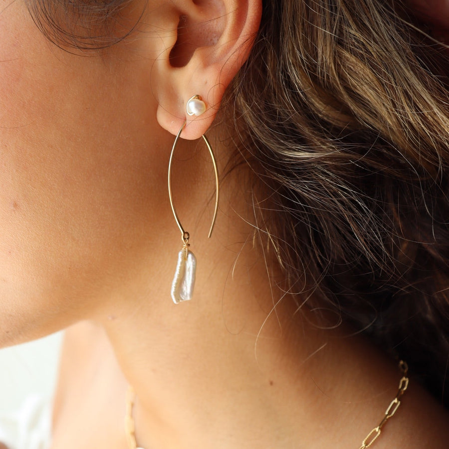 Model Wearing 14k gold fill Juno earrings pair with the pearl studs