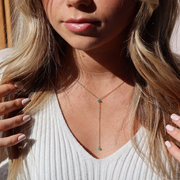 Model wearing 14k gold fill Green opal lariat. This necklace features our simple chain connected by the Green opal gemstone dangling on the lariat is another green opal lariat.