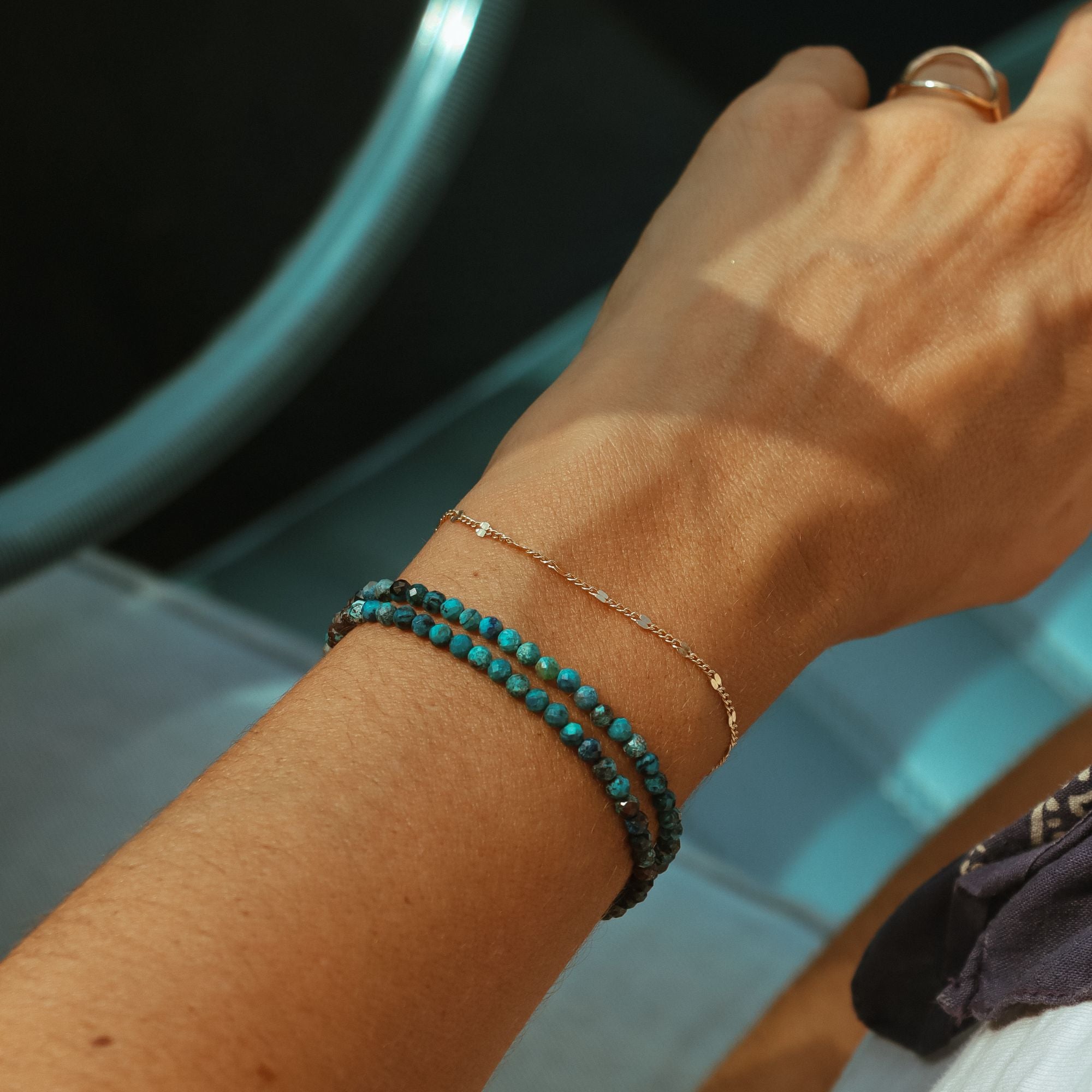 model wearing chrysocolla beaded bracelet with chain bracelet